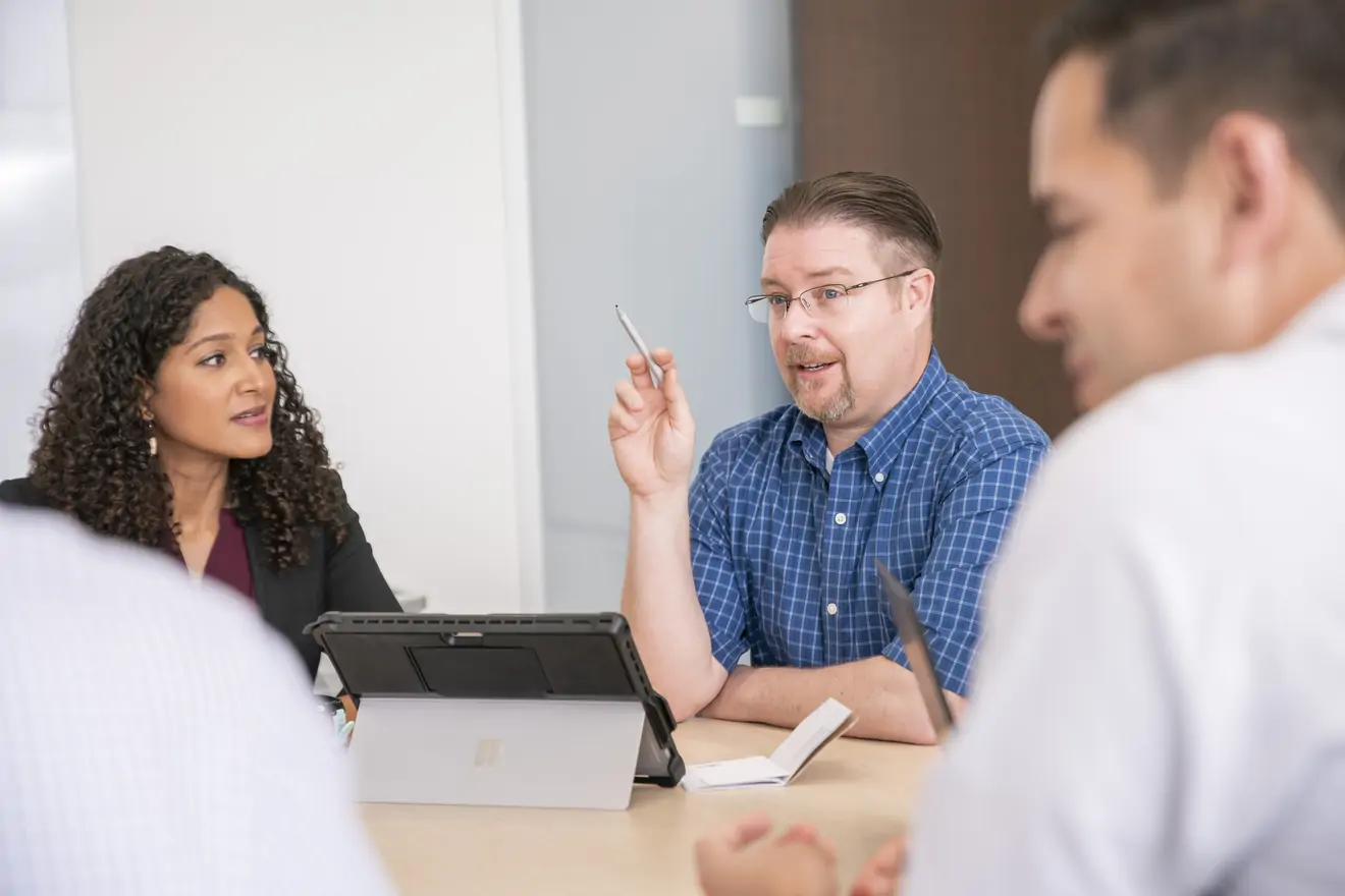 Employees at a meeting table