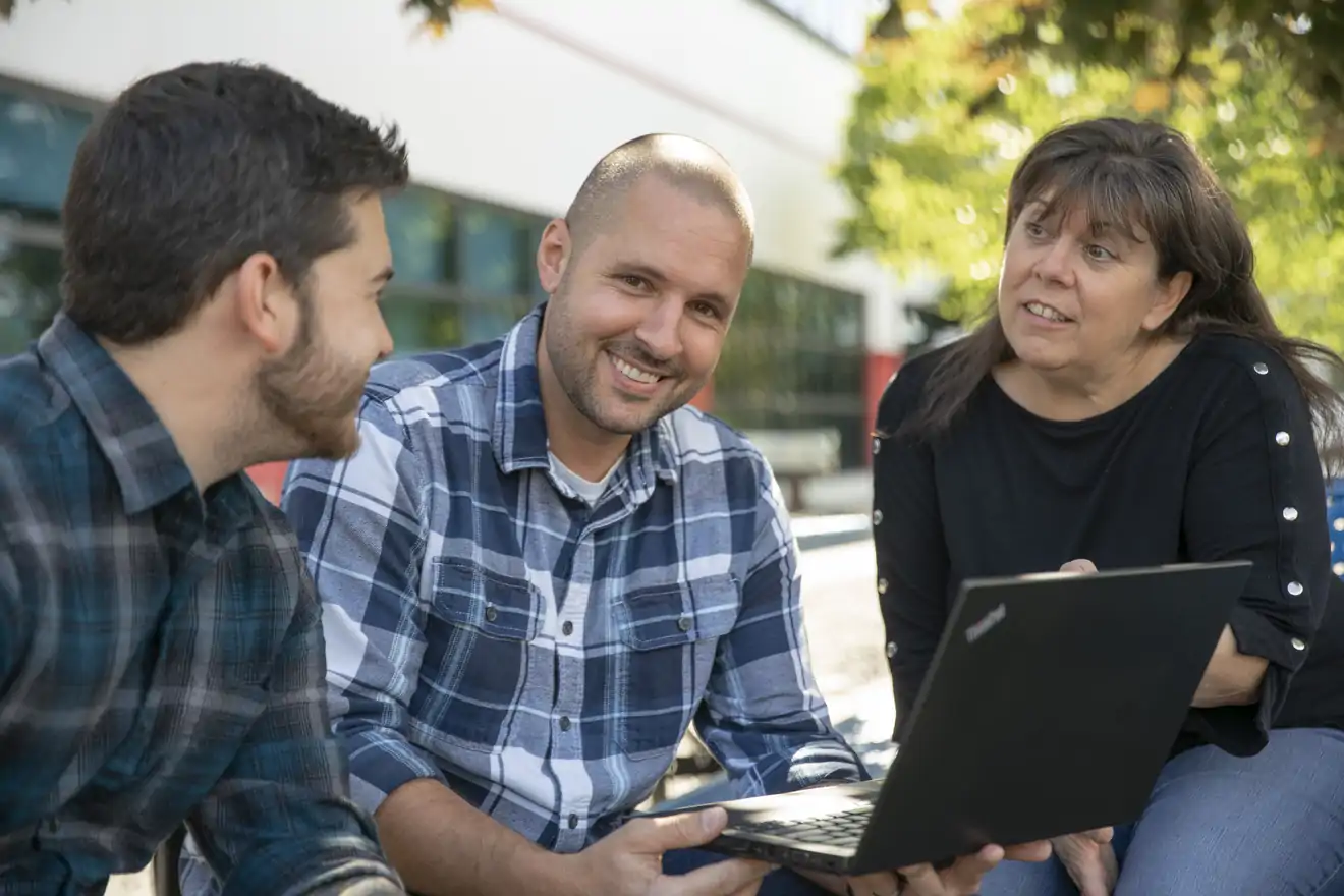 three employees conversating 