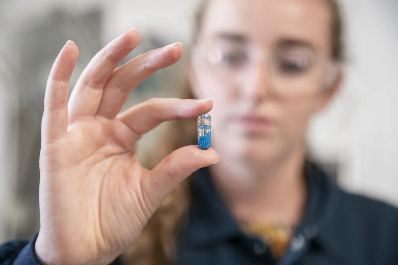 woman holding capsule