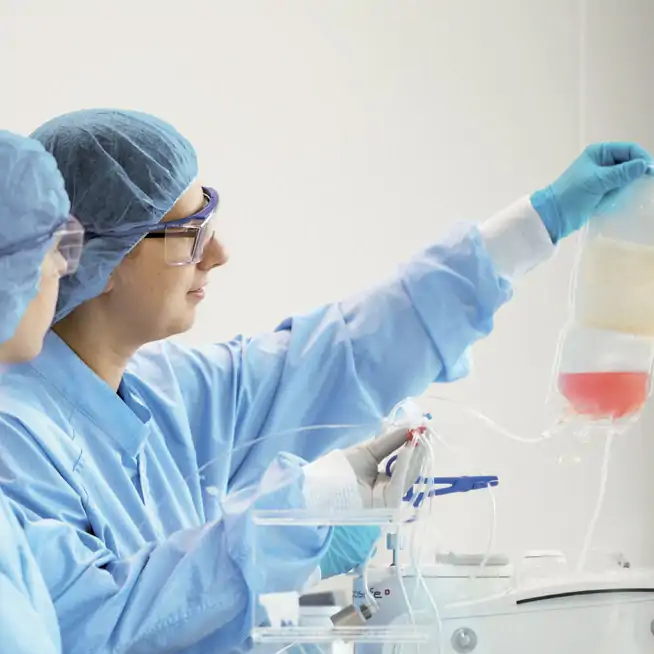 female techs holding fluid bag