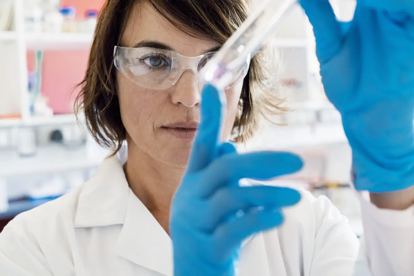 Woman in lab with vial 