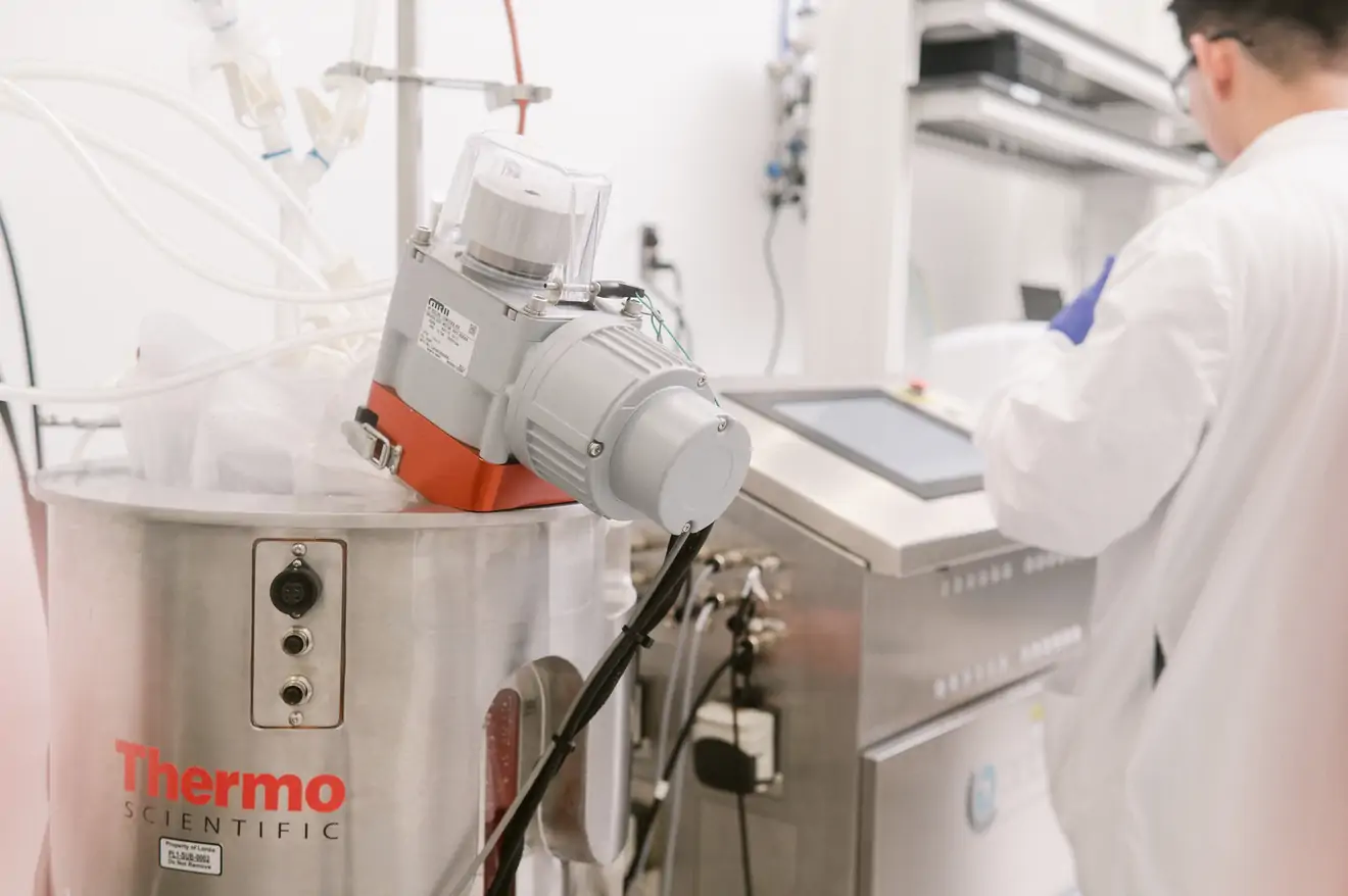 technician working with Thermo Scientific tank