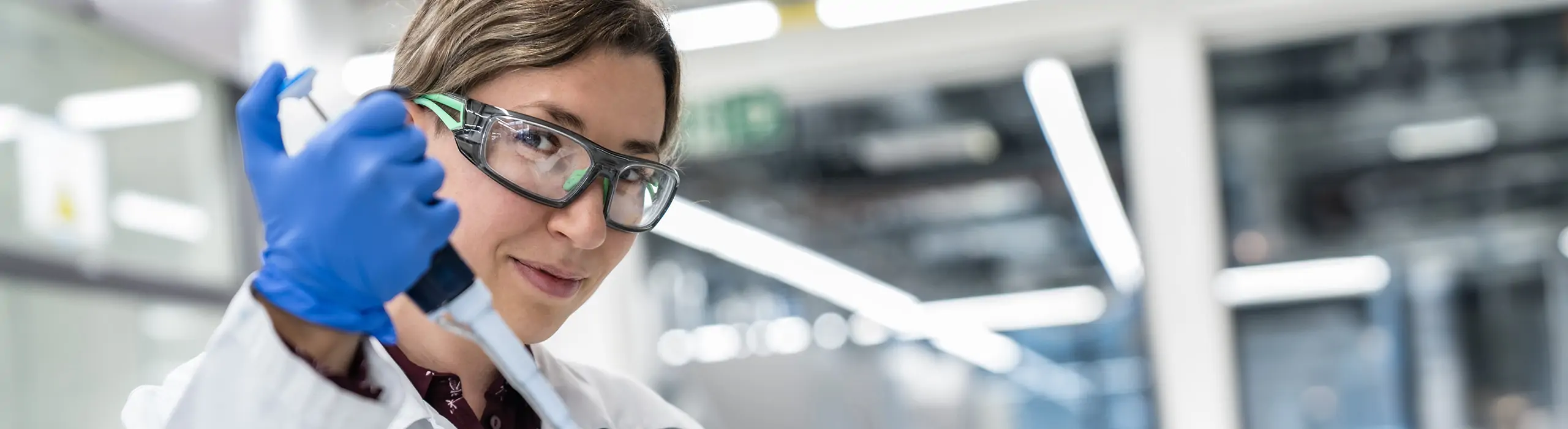 female technician using micropipette 