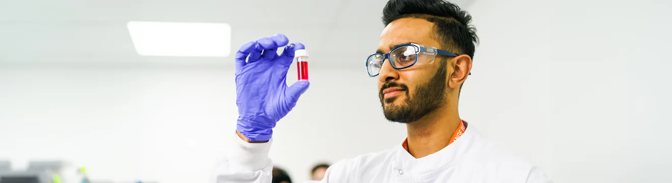 technician examining vial