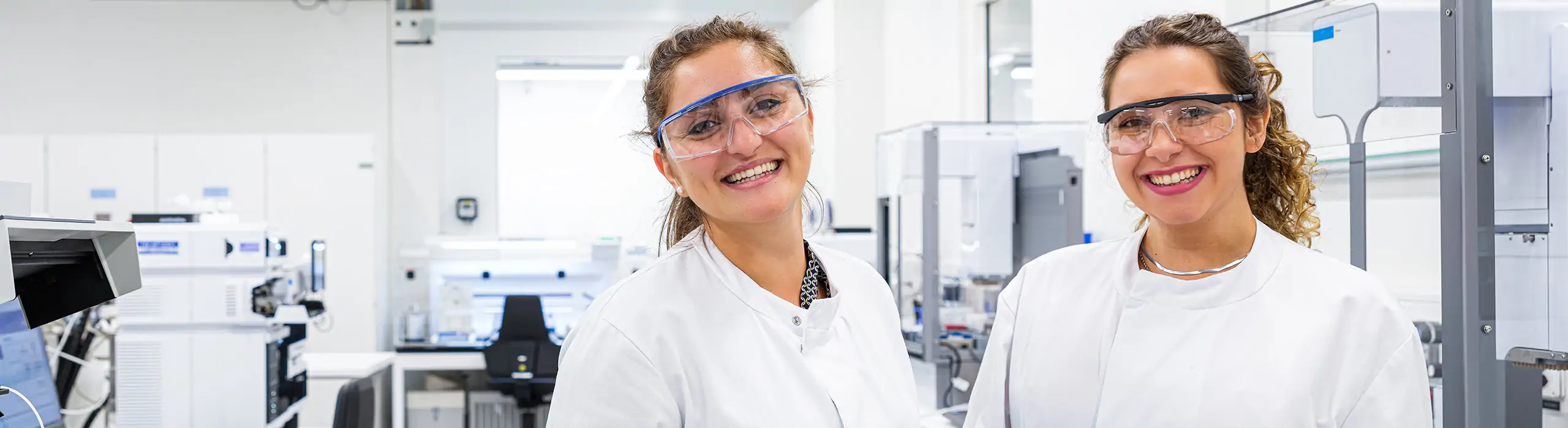 two women smiling in lab