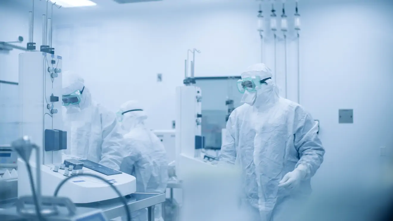 gowned technicians working in lab