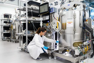 lab technician working at base of equipment