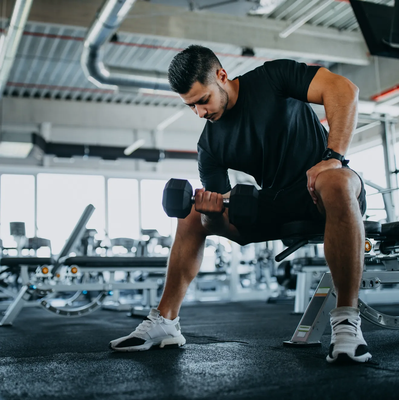 man in the gym lifting barbell