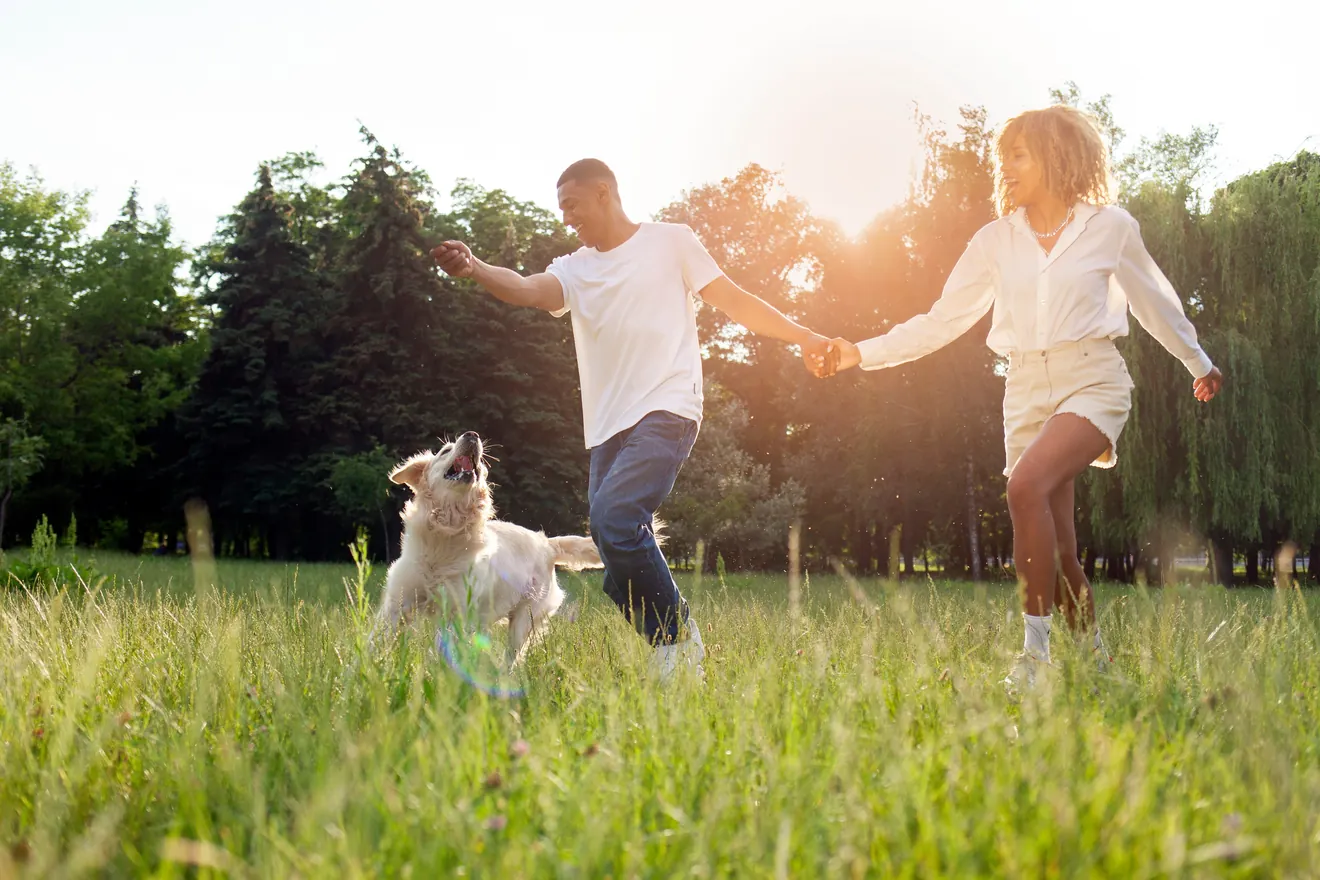 Couple running with dog