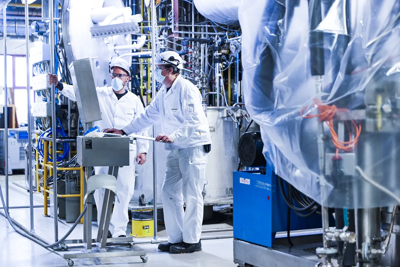 Two males in lab working on computer